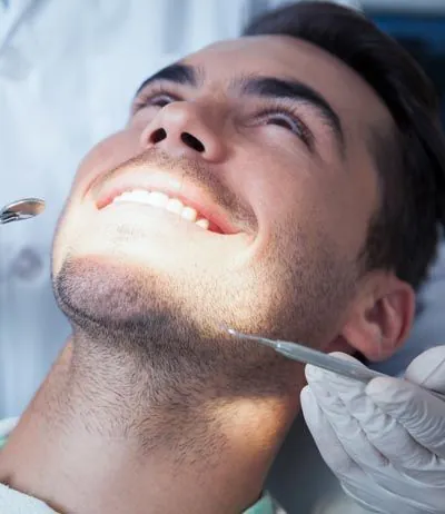 man getting dental care at Dat Complete Dentistry