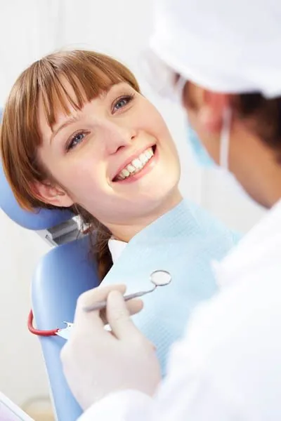 woman receiving dental care at Dat Complete Dentistry