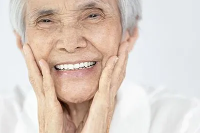 woman smiling with dental crowns from Dat Complete Dentistry