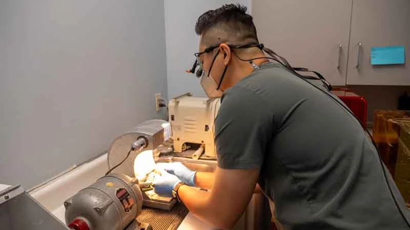 Dr. Dat Vu constructing dental restorations with high-tech equipment in the lab at Dat Complete Dentistry in Hatboro, PA